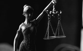 statue holding scales - reflecting balanced investment portfolio