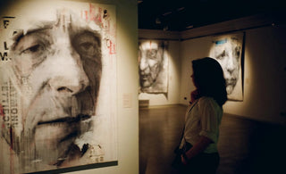 woman viewing fine art painting in art gallery
